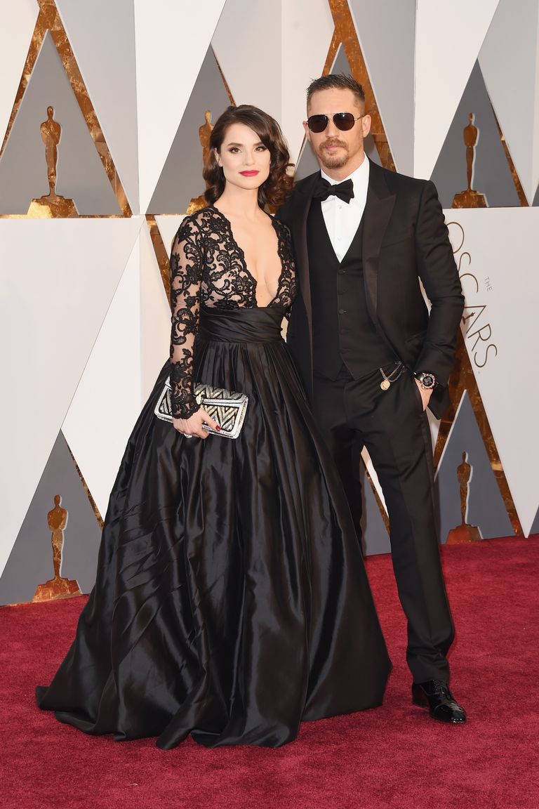 Tom Hardy and Charlotte Riley 
Suit by Gucci; watch by Bulgari; dress by Gauri & Nainika; jewels and clutch by Bulgari.