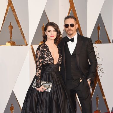 Tom Hardy and Charlotte Riley 
Suit by Gucci; watch by Bulgari; dress by Gauri & Nainika; jewels and clutch by Bulgari.