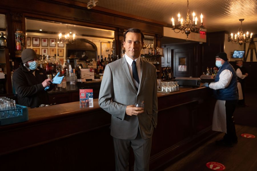 A wax replica of actor Jon Hamm holding a drink at the bar at Brooklyn steakhouse Peter Luger.