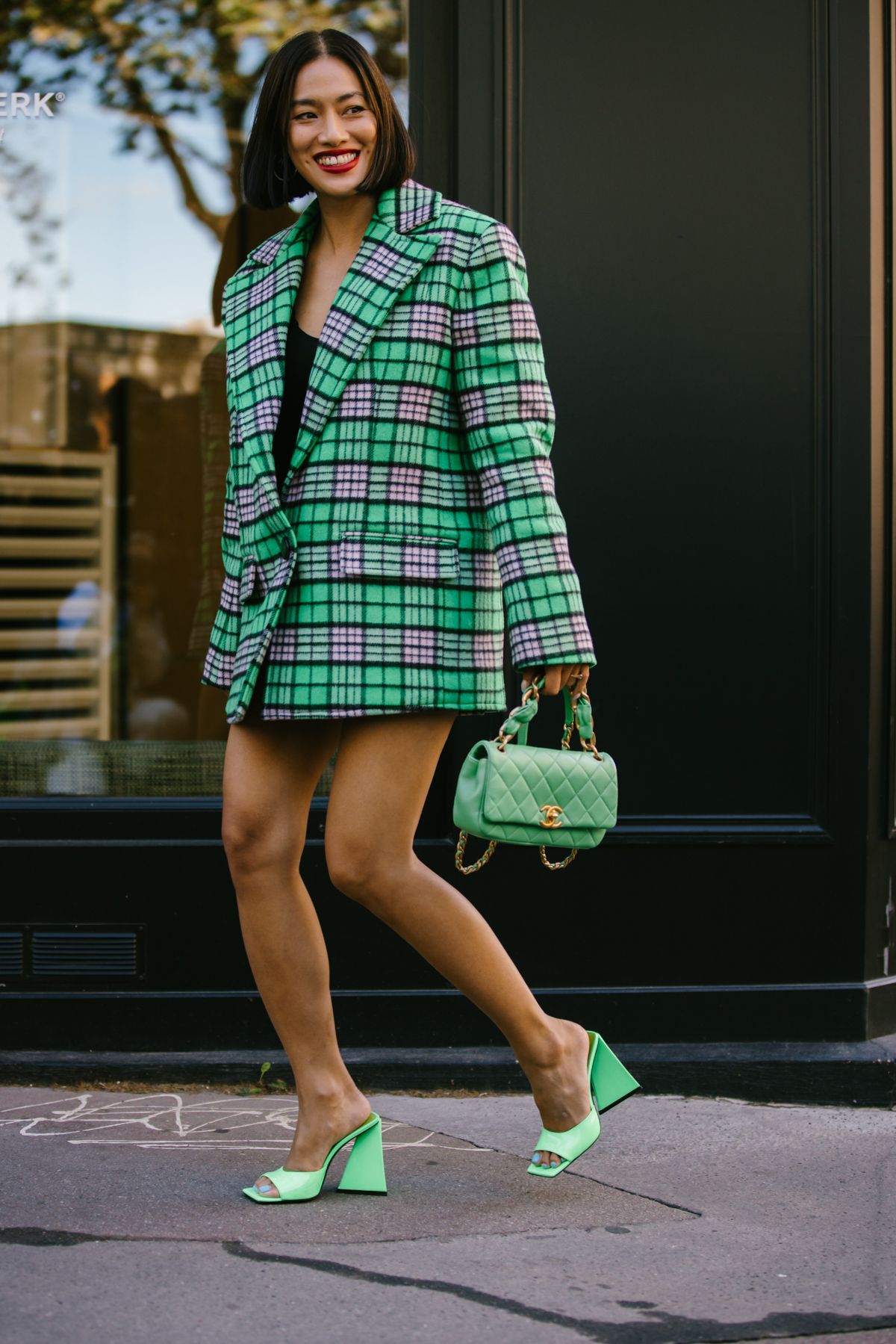 Fashion Blogger Thassia Naves wears a Chanel necklace, skirt and