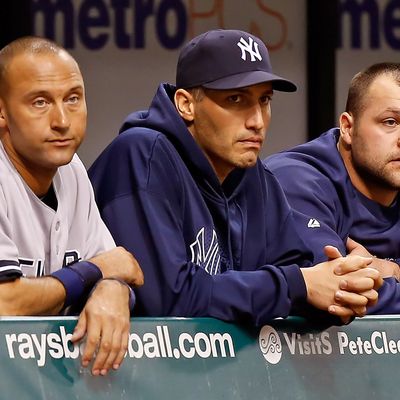 Infielder Derek Jeter #2 (left), pitcher Andy Pettitte #46 and pitcher Joba Chamberlain #62 of the New York Yankees watch the end of the game against the Tampa Bay Rays at Tropicana Field on September 4, 2012 in St. Petersburg, Florida.