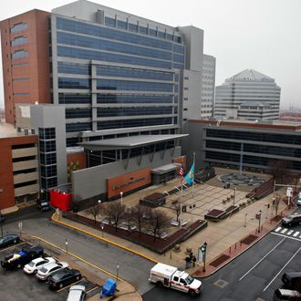 Law enforcement officials and investigators gather outside the New Castle County Courthouse in Wilmington, Del. on Monday, Feb. 11, 2013, after three people died Monday morning in a shooting at a courthouse, including the shooter, authorities said. (AP Photo/ Joseph Kaczmarek)