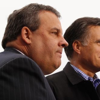 Former Massachusetts Governor and Republican presidential candidate Mitt Romney (R) and New Jersey Governor Chris Christie are interviewed on television after a campaign rally at a Hy Vee supermarket December 30, 2011 in West Des Moines, Iowa. Christie, a popular Republican governor who was urged to run for president earlier this year, appeared with Romney just days before the 