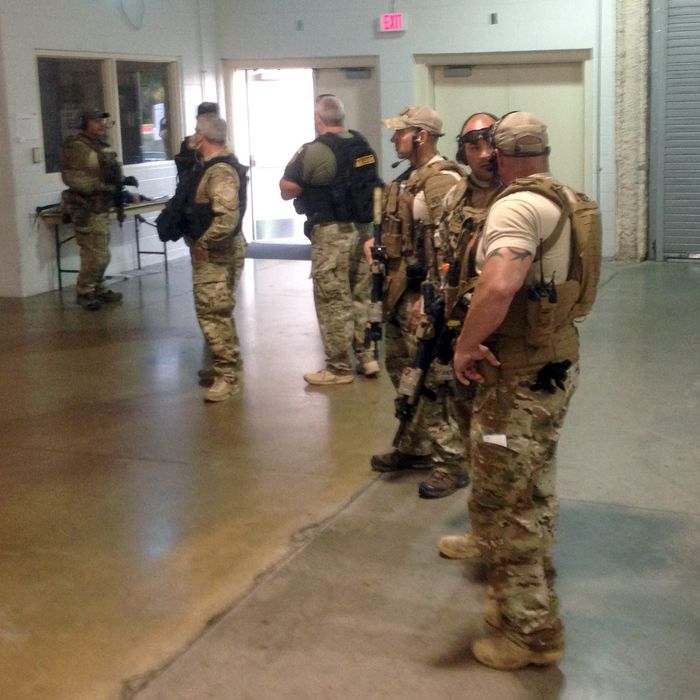 Members of the Garland Police Department are stand inside the Curtis Culwell Center on Sunday, May 3, 2015, in Garland, Texas. A contest for cartoons depictions of the Prophet Muhammad in the Dallas suburb is on lockdown Sunday after authorities reported a shooting outside the building. (AP Photo Nomaan Merchant)