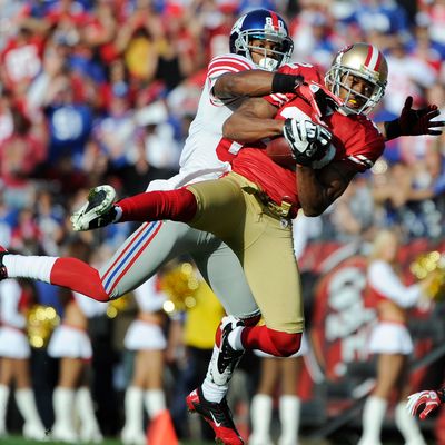 Carlos Rogers #22 of the San Francisco 49ers intercepts the pass in front of Victor Cruz #80 of the New York Giants during an NFL football game at Candlestick Park November 13, 2011 in San Francisco, California.