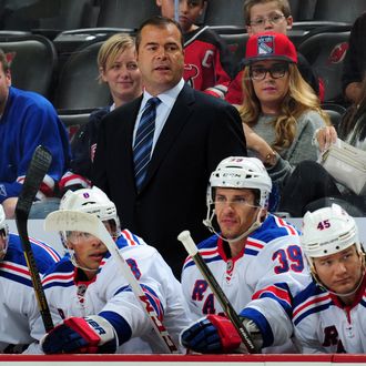 Alain Vigneault of the New York Rangers looks on during the first period of a preseason game against the New Jersey Devils on September 16, 2013 at the Prudential Center in Newark, New Jersey.