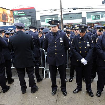 NYPD officers turn their backs on Mayor Bill de Blasio at the funeral for Officer Weijian Liu, 2014.