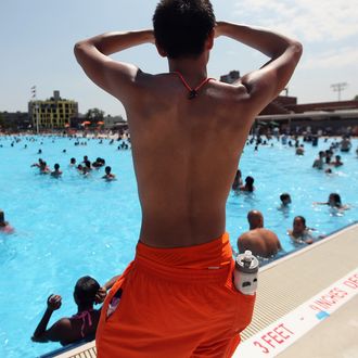 NEW YORK, NY - JUNE 28: A lifeguard keeps watch on opening day of the newly renovated McCarren Park Pool on June 28, 2012 in the Brooklyn borough of New York City. The historic 37,000 square-foot pool had been closed since 1983 but has been rejuvenated by a $50 million restoration. Today is the first day New York City public pools opened for the summer. (Photo by Mario Tama/Getty Images)