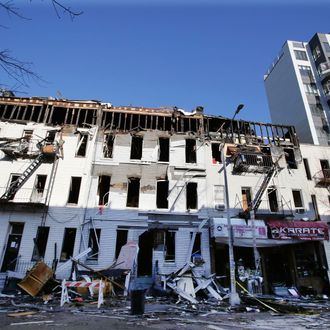 A row of buildings damaged by a fire in the Bushwick section of Brooklyn is shown, Wednesday, March 30, 2016, in New York. The fire began Tuesday night on the first floor of a 3-story row house and quickly spread to other buildings. (AP Photo/Mark Lennihan)
