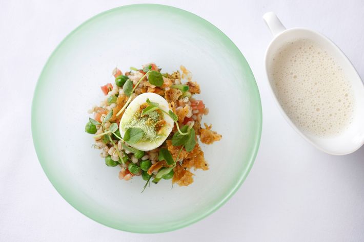 Soft-boiled egg, chicken cracklings, sugar snap peas, and barley.