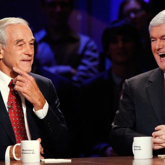 HANOVER, NH - OCTOBER 11: U.S. Rep. Ron Paul (R-TX) listens while former U.S. Speaker of the House Newt Gingrich laughs during a presidential debate hosted by Bloomberg and the Washington Post on October 11, 2011 at Dartmouth College in Hanover, New Hampshire. The event moderated by U.S. television talk show host Charlie Rose and featuring eight Republican candidates, presents the first debate of the 2012 political season focused solely on the economy. (Photo by Scott Eells-Pool/Getty Images)