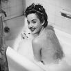Smiling woman in bubble bath
