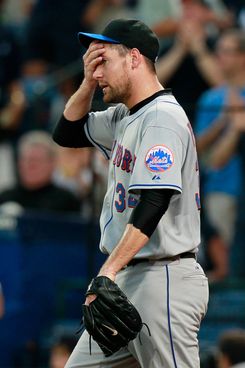 Pitcher Johan Santana wears his new cap and jersey during a news News  Photo - Getty Images