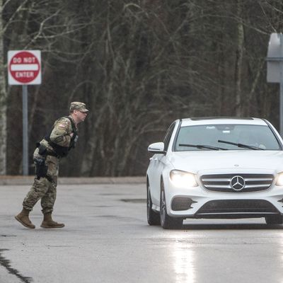 A member of the military police speaks to an out-of-state driver on Sunday at a checkpoint in Richmond, Rhode Island that was set up in the first rest stop on I-95 after the Connectictut-Rhode Island border.