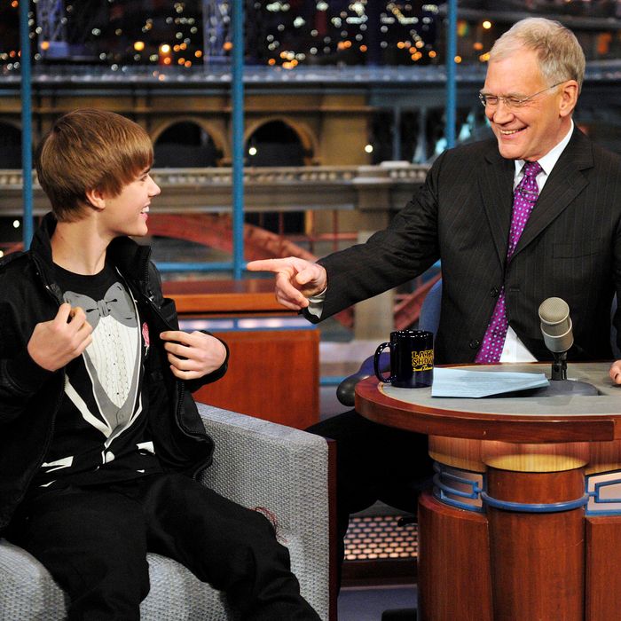 Justin Bieber, left, shows Dave his tuxedo shirt on the Late Show with David Letterman, Monday Jan. 31, 2011 on the CBS Television Network.Photo: John Paul Filo/CBS?2011 CBS Broadcasting Inc. All Rights Reserved