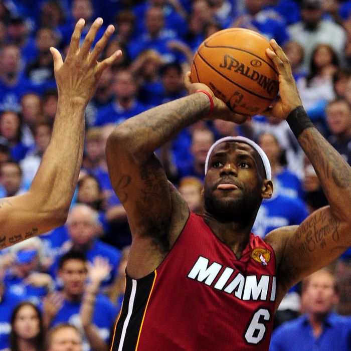 LeBron James (R) of the Miami Heat shoots against the Dallas Mavericks during Game 3 of the NBA Finals at the AmericanAirlines Center in Dallas on June 5, 2011. The Heat defeated the Mavericks 88-86. AFP PHOTO/Mark RALSTON (Photo credit should read MARK RALSTON/AFP/Getty Images)