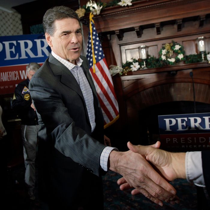 Republican presidential candidate, Texas Gov. Rick Perry shakes hands during a campaign stop at Bayliss Park Hall, Wednesday, Dec. 14, 2011, in Council Bluffs, Iowa. (AP Photo/Eric Gay)