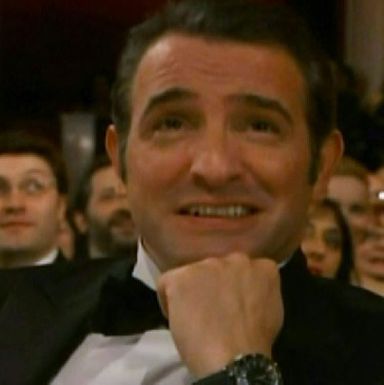 A roving cameraman thought he could catch Jean Dujardin at a non-dapper moment. Foolish cameraman! Does he not realize that Dujardin does hot yoga in a dinner jacket and clutches a martini even when sitting on the toilet?
