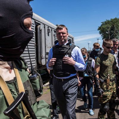 Alexander Hug (C), Deputy Chief Monitor of the Organisation for Security and Cooperation in Europe (OSCE) Special Monitoring Mission to Ukraine, visits a train containing the bodies of victims of the Malaysia Airlines flight MH17 crash on July 21, 2014 in Torez, Ukraine. Together with Dutch inspectors, the storage conditions were declared acceptable, though it is still unclear where or when the train will be moved. Malaysia Airlines flight MH17 was travelling from Amsterdam to Kuala Lumpur when it crashed killing all 298 on board including 80 children.