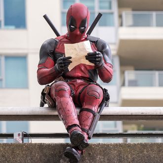 Ryan Reynolds as Deadpool relaxes before leaping into battle.