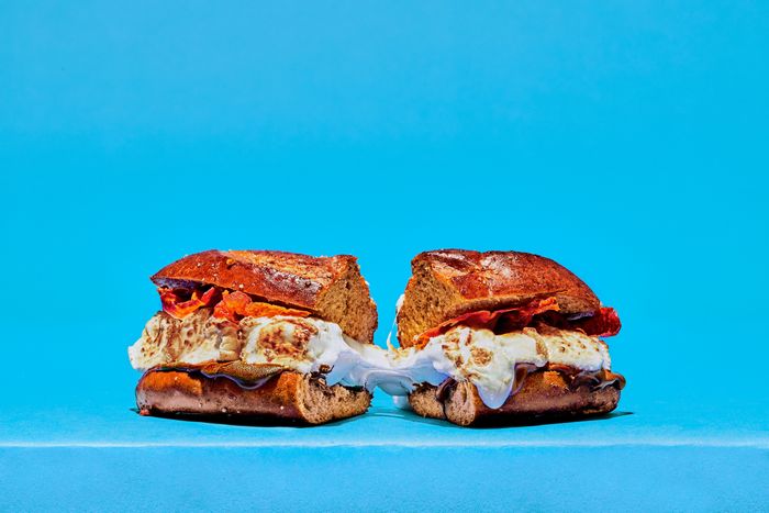 A close up of a cut S'moagie sandwich showcasing strands of marshmallow goo 