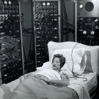 Woman sleeping with electrodes on head.