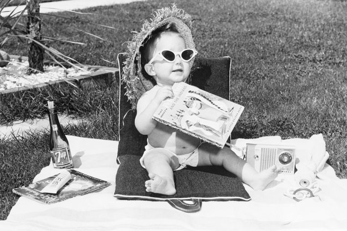  black and white photo of baby with sunglasses sunbathing - strategist best skin care products and best sunscreens