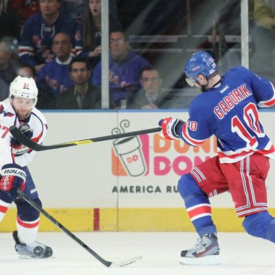 Marian Gaborik #10 of the New York Rangers controls the puck against Karl Alzner #27 of the Washington Capitals