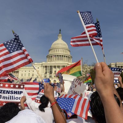 epa03657247 People show their support during a rally for comprehensive immigration reform on the West Front of the US Capitol in Washington DC, USA, 10 April 2013. Several thousand people attended the rally. EPA/MICHAEL REYNOLDS