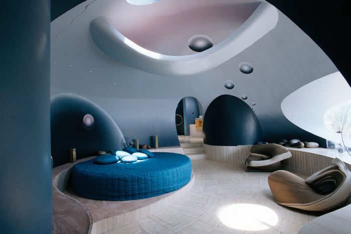 A futuristic rounded bedroom in the Bubble Palace is decorated by a contemporary artist in soft blues.