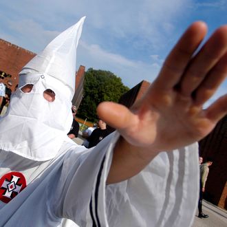 A member of the Ku Klux Klan salutes during American Nazi Party rally at Valley Forge National Park September 25, 2004 in Valley Forge, Pennsylvania. Hundreds of American Nazis from around the country were expected to attend. 