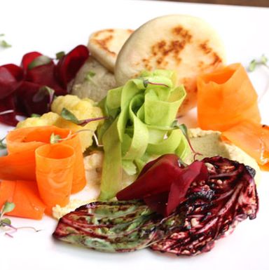 balsamic vinegar beets, saffron cauliflower, ginger-honey carrots, pesto-and-celery-leaf-marinated daikon, blueberry gastrique, hummus, piadina bread