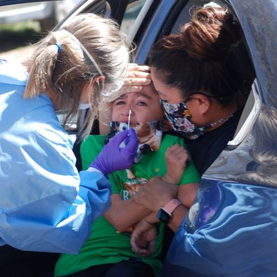 Ashley Pyne, right, helps her son, Elijah, complete a nasal swipe for COVID-19 testing in Picuris Pueblo, N.M., . Small Native American pueblo tribes across New Mexico are embracing extraordinary social distancing measures that include guarded roadblocks and universal testing for the coronavirus in efforts to insulate themselves from a contagion with frightening echoes of the past Virus Outbreak Endangered Tribes, Picuris Pueblo, United States - 23 Apr 2020