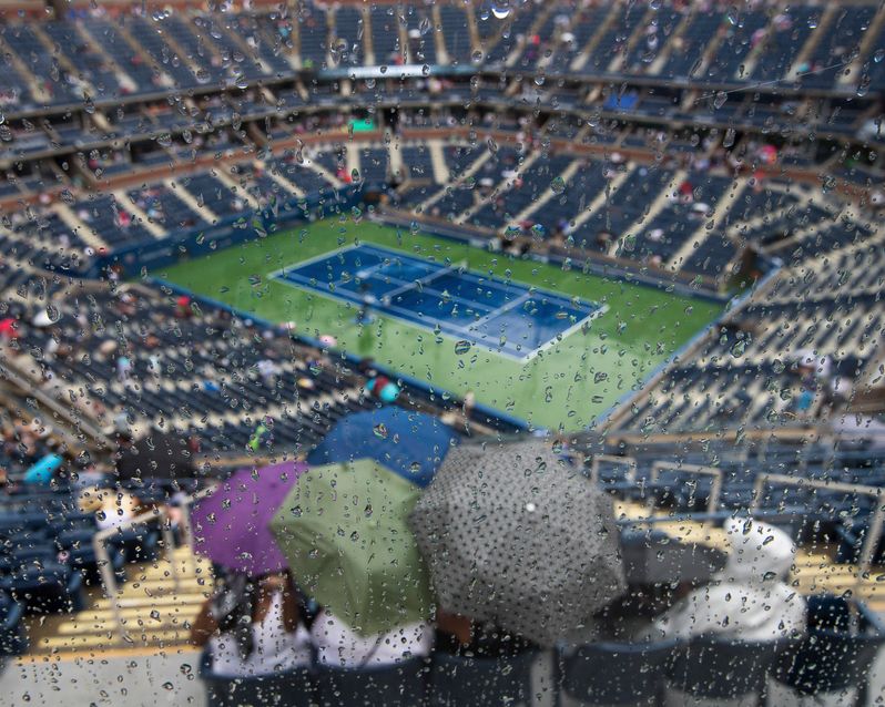 Raindrops dot a window at Arthur Ashe Stadium during a rain delay at the U.S. Open tennis tournament in New York.