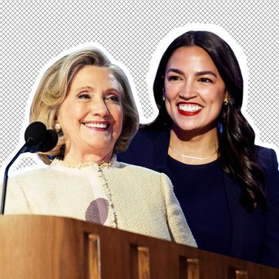 Hillary Clinton, smiling in a white tweed jacket, stands at a lectern in this photo illustration. Behind her left shoulder is Alexandria Ocasio-Cortez, also smiling in red lipstick and a dark suit. 