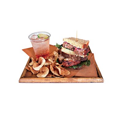 Turkey meatloaf sandwich with pickled red onion, curly endive, and mayonnaise on challah, with housemade potato chips and vanilla pear soda.