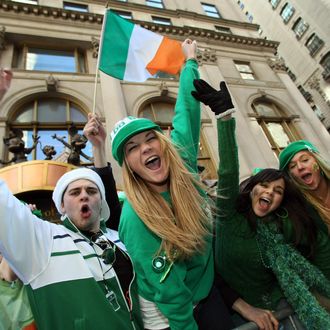 Parade watchers cheer on marching bands as they make their way up 5th Avenue during the St. Patrick's Day Parade on March 17 , 2008 in New York. AFP PHOTO/TIMOTHY A. CLARY (Photo credit should read TIMOTHY A. CLARY/AFP/Getty Images)