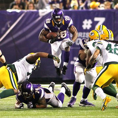 Adrian Peterson #28 of the Minnesota Vikings runs against the Green Bay Packers on December 30, 2012 at Mall of America Field at the Hubert H. Humphrey Metrodome in Minneapolis, Minnesota. The Vikings defeated the Packers 37-34.