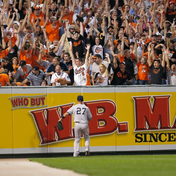Left fielder Raul Ibanez #27 of the New York Yankees looks on as fans celebrate a three RBI home run hit by Matt Wieters #32 of the Baltimore Orioles during the first inning at Oriole Park at Camden Yards on September 6, 2012 in Baltimore, Maryland.