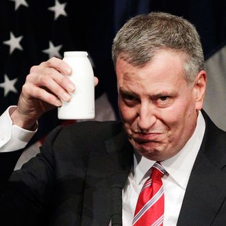New York Mayor Bill de Blasio holds up a bottle as he takes a drink during his State of the City address at LaGuardia Community College in the Queens borough of New York, Monday, Feb. 10, 2014. De Blasio, delivering one of the most important speeches of his young administration, outlined his vision for New York and offered a glimpse into his signature goal of fighting the city's widening income inequality gap. (AP Photo/Mark Lennihan)