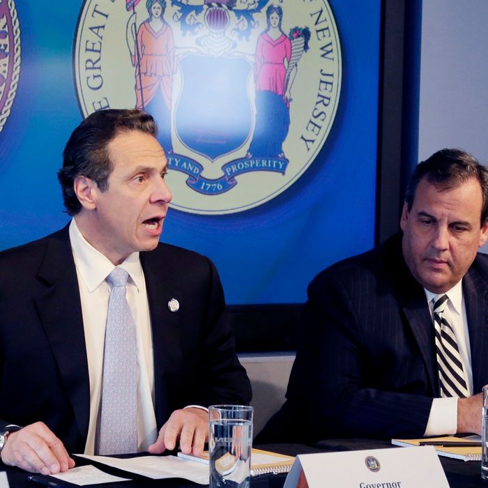 New York Governor Andrew Cuomo, left, speaks as New Jersey Governor Chris Christie listens at a news conference, Friday, Oct. 24, 2014 in New York. The governors announced a mandatory quarantine for people returning to the United States through airports in New York and New Jersey who are deemed 