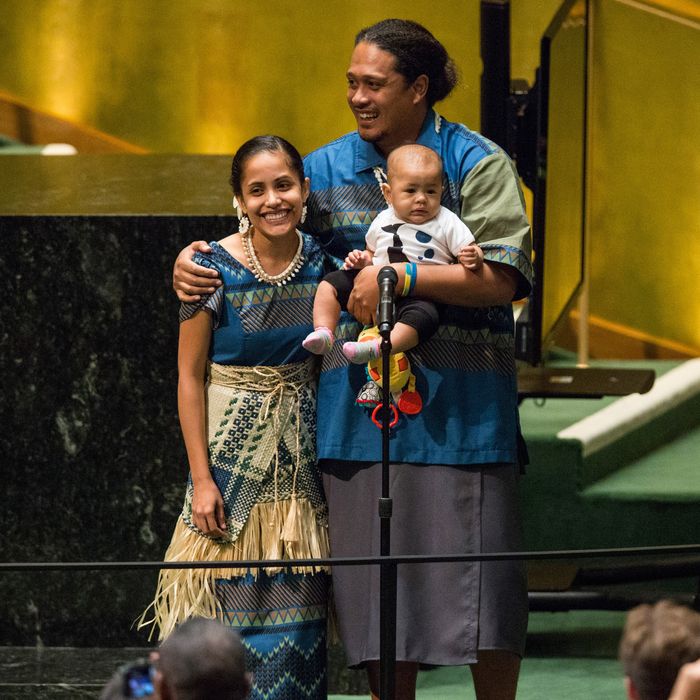 Kathy Jetnil-Kijiner, a civil society representative from the Marshall Islands, recieves a standing ovation with her husband and child after speaking at the United Nations Climate Summit on September 23, 2014 in New York City. 