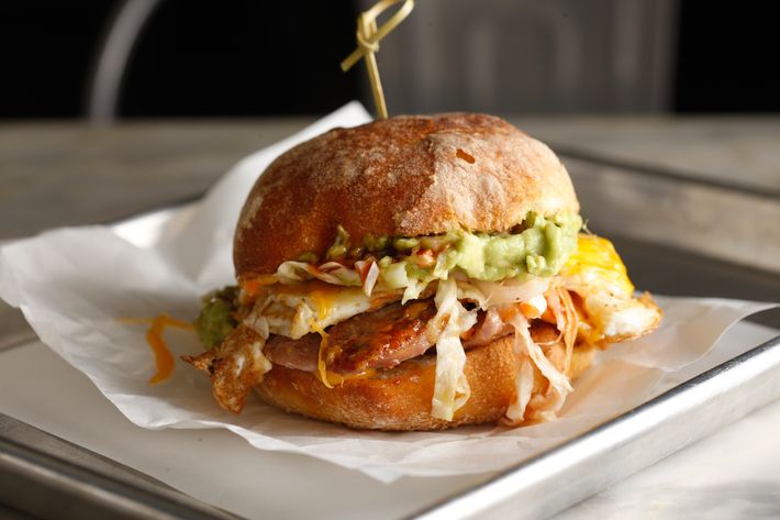 Roadhouse: Pork sausage, sharp Cheddar, avocado, slaw, barbecue sauce, Pugliese roll.