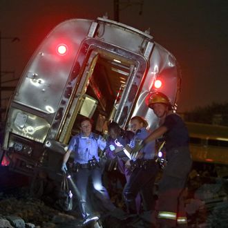 Emergency personnel work the scene of a deadly train wreck, Tuesday, May 12, 2015, in Philadelphia. An Amtrak train headed to New York City derailed and crashed in Philadelphia. (AP Photo/ Joseph Kaczmarek)