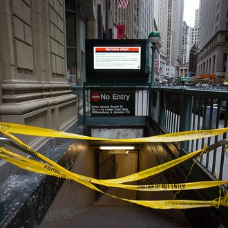 A subway station's entrance is blocked by yellow tape in New York, U.S., on Monday, Nov. 5, 2012. Commuters in New York and New Jersey face gasoline lines and miles of traffic jams as the metropolitan area struggles with the chaos that remains in the wake of superstorm Sandy. 