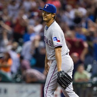 HOUSTON, TX - APRIL 02: Yu Darvish #11 of the Texas Rangers reacts after not being able to field a line drive back through his legs in the ninth inning by Marwin Gonzalez #9 of the Houston Astros (not pictured) to break up a perfect game at Minute Maid Park on April 2, 2013 in Houston, Texas. (Photo by Bob Levey/Getty Images)