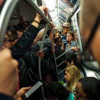 Morning commuters crowd into a Metropolitan Transportation Authority subway car June 10, 2014 in New York City.