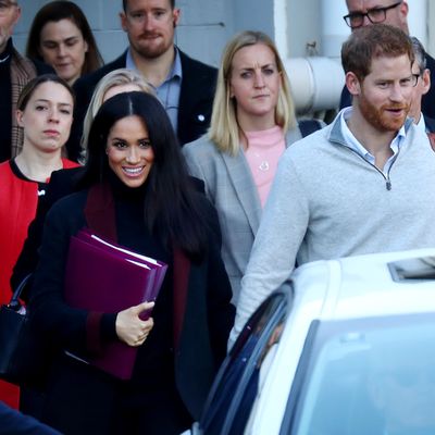Meghan Markle (with binders) and Prince Harry in Sydney.