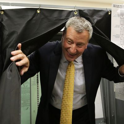 Public Advocate and mayoral candidate Bill de Blasio emerges from a voting booth after voting in the New York City mayoral primary on September 10, 2013 in the Brooklyn borough of New York City. In recent polls by Quinnipiac University, de Blasio is now close to the 40 percent threshold he'd need to avoid a runoff in the Democratic primary. 