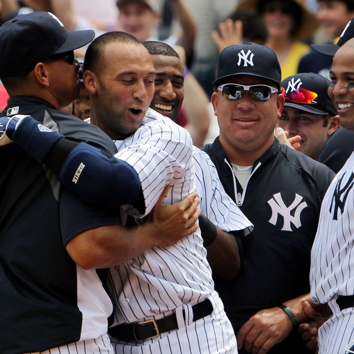 NEW YORK, NY - JULY 09: Derek Jeter #2 of the New York Yankees celebrates at home with teammates Alex Rodriguez #13, Bartolo Colon #40 and Andruw Jones #18 after hitting a solo home run in the third inning for career hit 3000 while playing against the Tampa Bay Rays at Yankee Stadium on July 9, 2011 in the Bronx borough of New York City. (Photo by Michael Heiman/Getty Images)